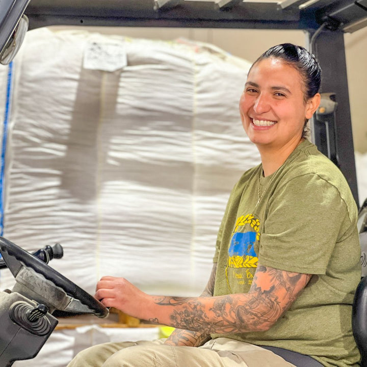 female worker driving forklift 